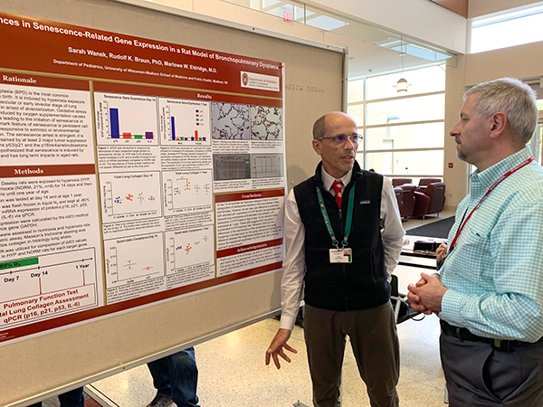 Critical Care senior scientist Rudolf Braun, PhD, discusses his poster on senescense-related gene expression in a rat model of bronchopulmonary dysplasia with Hematology, Oncology & Bone Marrow Transplant faculty member Mario Otto, MD, PhD.