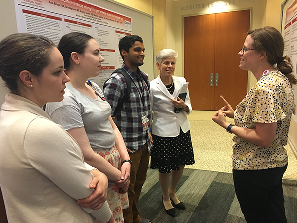 Jessica Babal, MD (far right), discusses her poster with chair Ellen Wald, MD, and residents Allison Heizelman, MD, Collette Chorney, MD, and Shawn Damodharan, MD