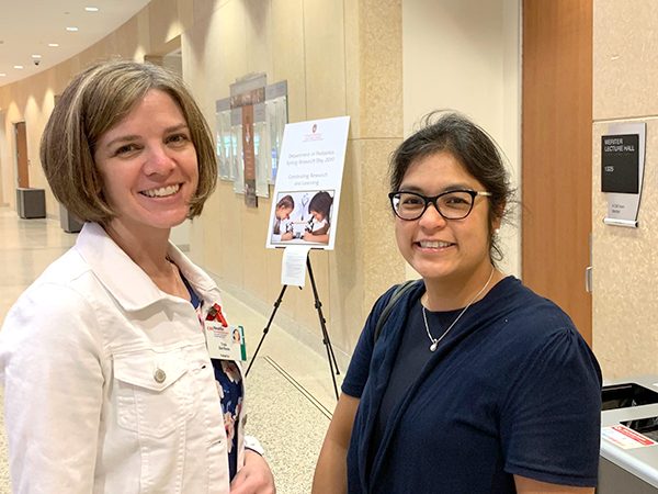 Research grants specialist Trish Barribeau talks with Allergy, Immunology and Rheumatology faculty member Anne Marie Singh, MD.