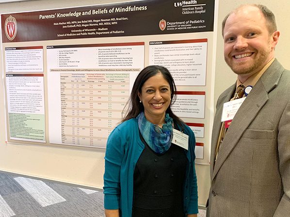 General Pediatrics and Adolescent Medicine faculty member Mala Mathur, MD, MPH, shares her poster on parental understanding of mindfulness with Allergy, Immunology and Rheumatology faculty member Eric Schauberger, DO, PhD.