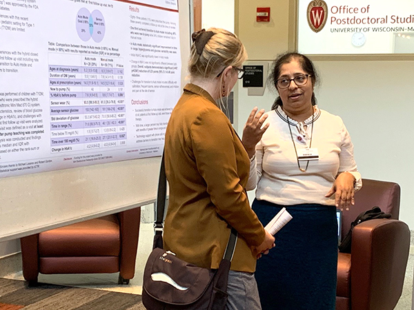 General Pediatrics and Adolescent Medicine Division Chief Megan Moreno, MD, MSEd, MPH, talks with Endocrinology postdoctoral fellow Yashoda Naik, MD, during the Research Day poster session.