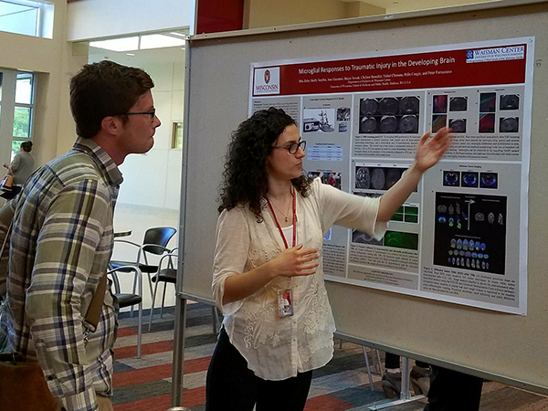 Dila Zafer, a research associate in the laboratory of Pelin Cengiz, MD, discusses her poster