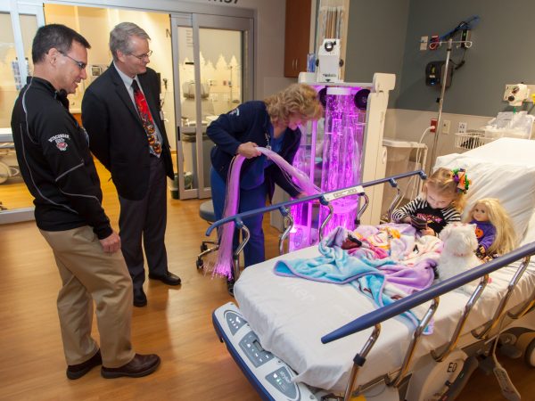 Staff demonstrate a “distraction machine” that’s used to help relax anxious children.