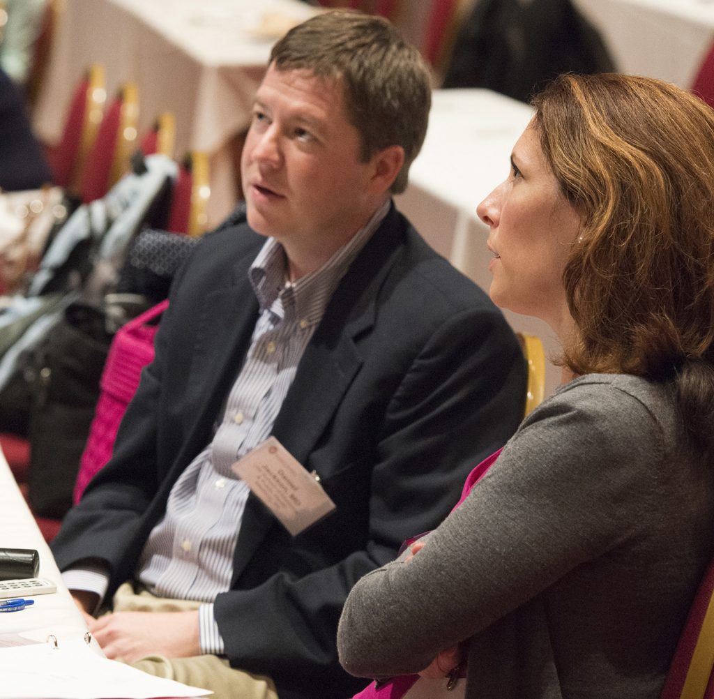 Seminars in Pediatrics co-directors Dan Jackson, MD, and Kristin Shadman, MD, listen to Dr. Sampson’s talk.