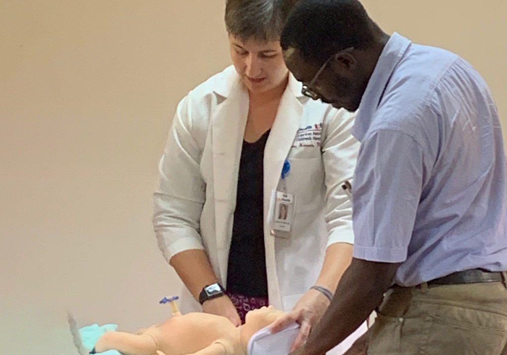 Laura Houser, MD, demonstrates a procedure with an infant simulation doll