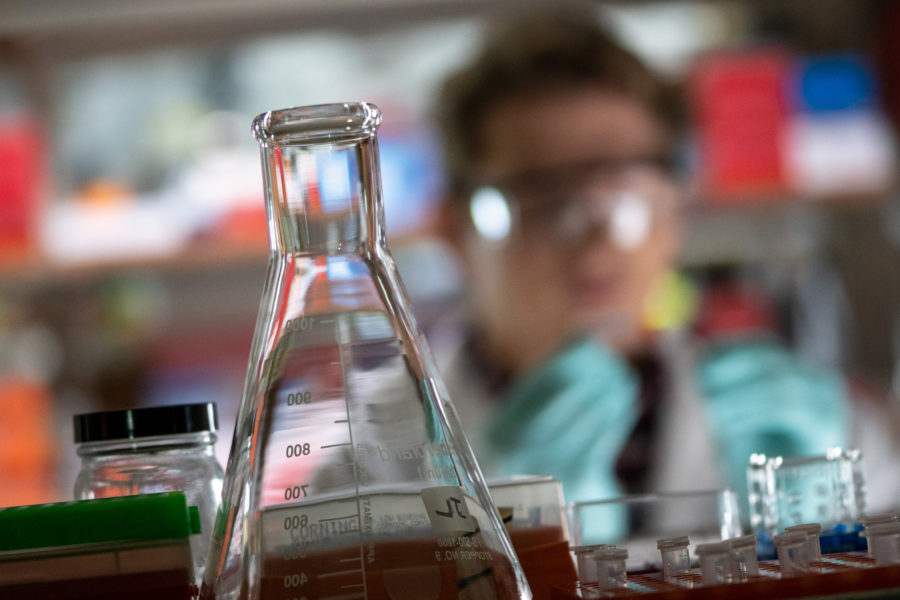 researcher in a lab with a beaker