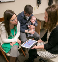 care provider, parents and young child discussing genetic screening