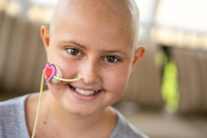 Smiling child with nasal feeding tube