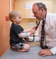 doctor and child holding stethoscope