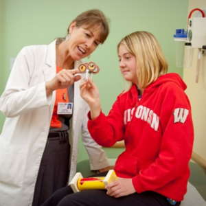 Nurse showing cardiovascular model to child