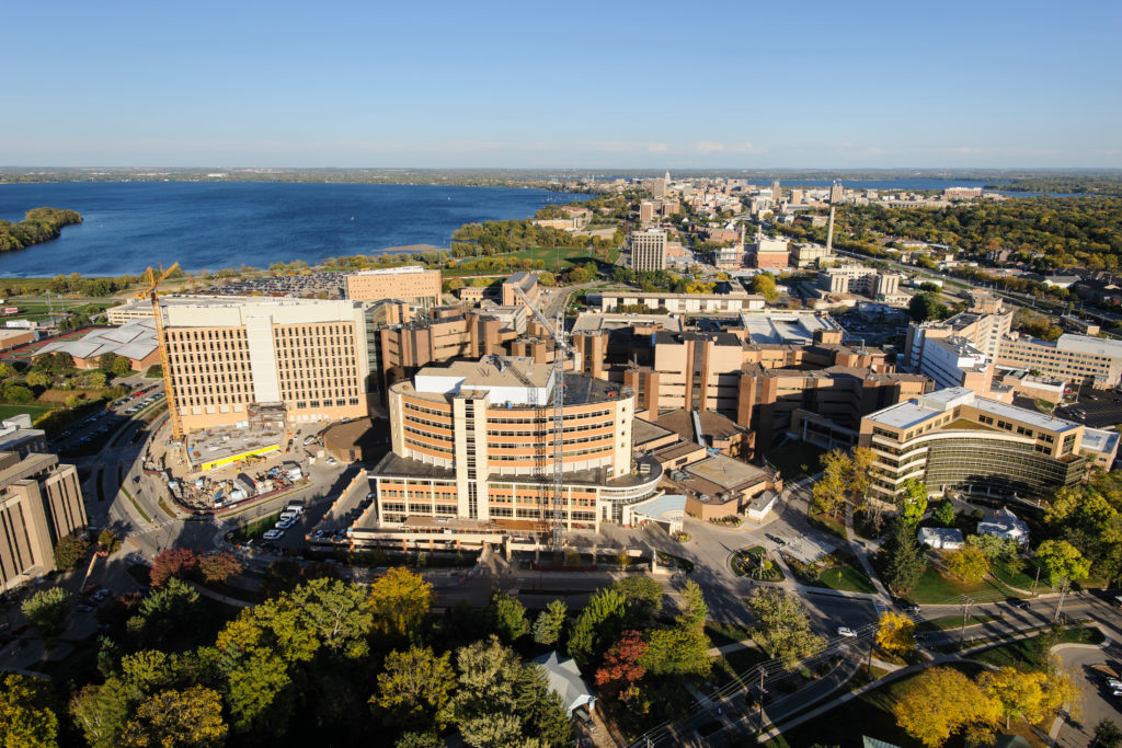 The medical area of the western side of the University of Wisconsin-Madison campus is pictured in an aerial view during autumn on Oct. 12, 2013. From Left to right, prominent campus facilities include the Waisman Center, Wisconsin Institutes for Medical Research (WIMR), UW Hospital and Clinics and American Family Children's Hospital, UW Medical Foundation Centennial Building, and Veterans Administration Hospital. On the horizon, from left to right, is Lake Mendota, the downtown Madison skyline, Wisconsin State Capitol, and Lake Monona. The photograph was made from a helicopter looking east. (Photo by Jeff Miller/UW-Madison)