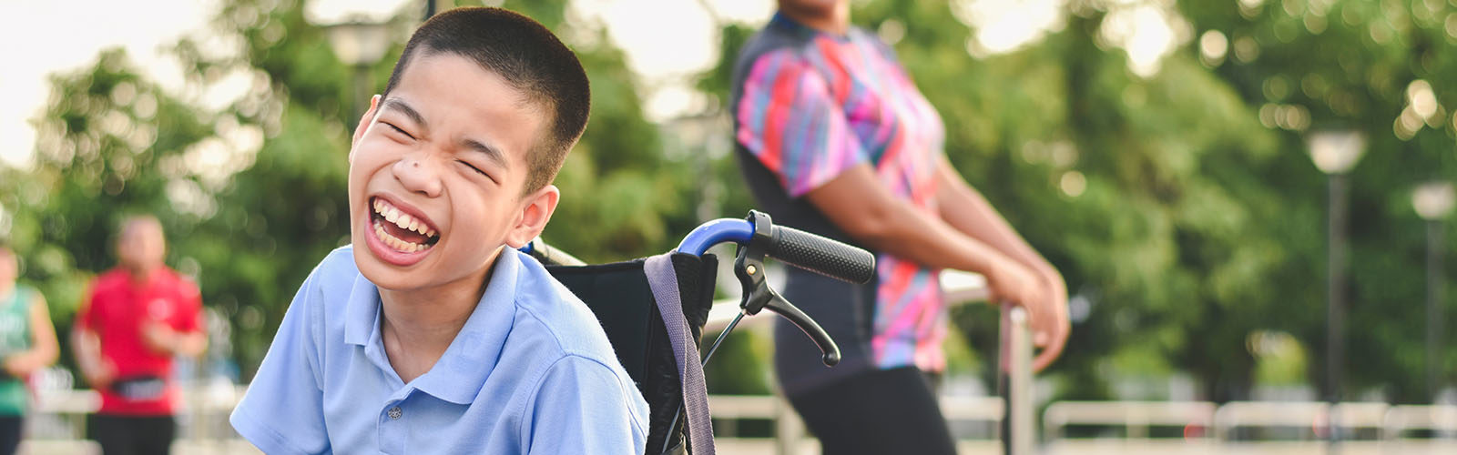 smiling child in a wheelchair