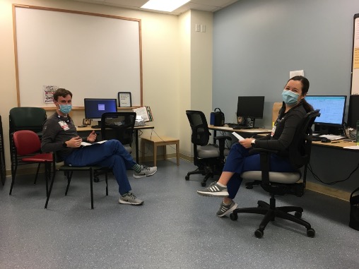 two doctors seated at two desks