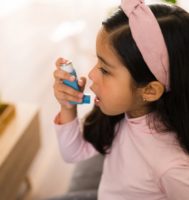 A child using an asthma inhaler. Source: Shutterstock