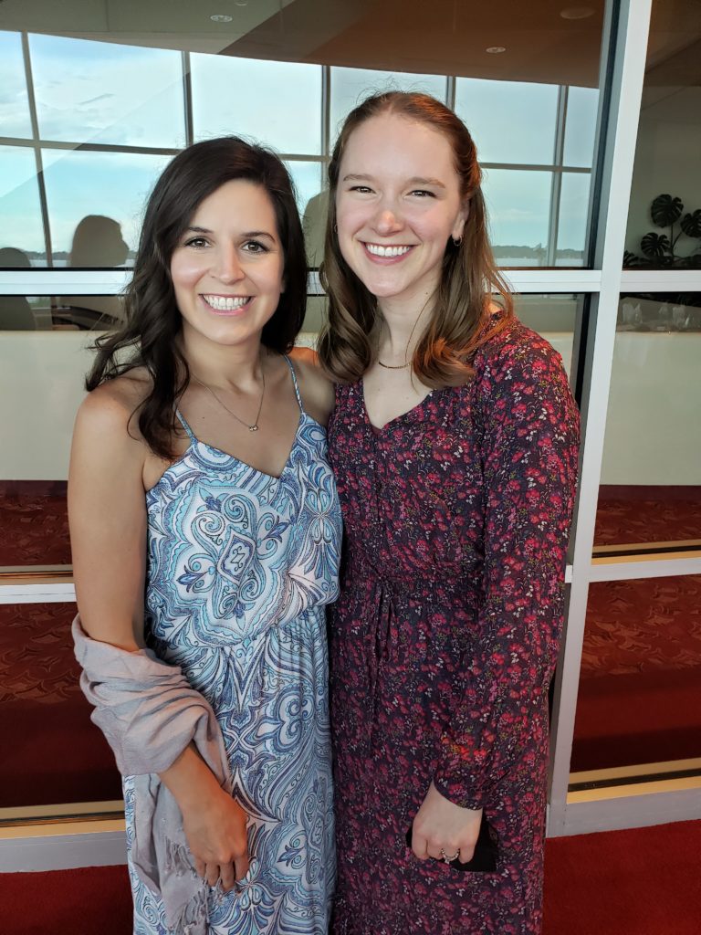 two smiling women standing side by side