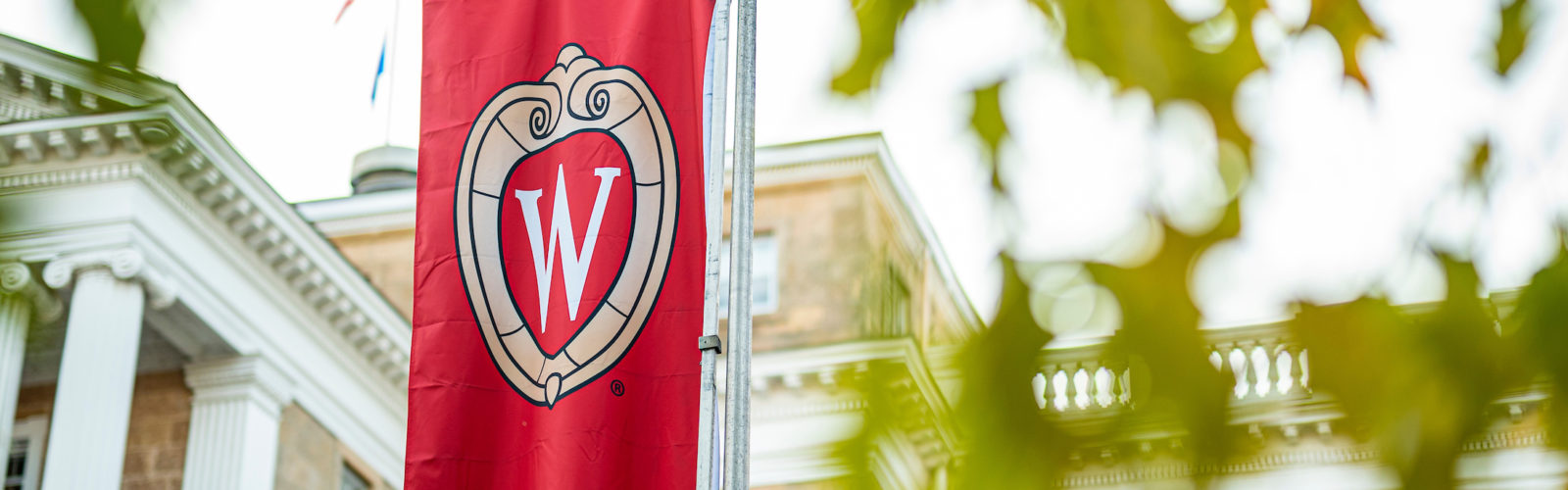 University of Wisconsin @ shield on a red banner