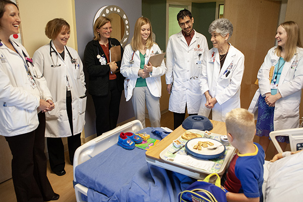 group of providers in a pediatric patient room