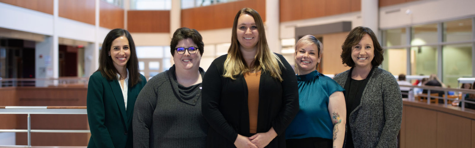 5 people standing in front of the Ebling Library in the Health Sciences Learning Center.