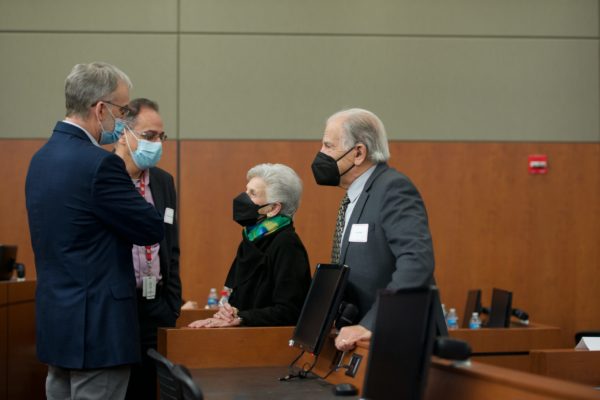 Dr. Carter Ralph, Dr. Petros Anagnostopoulos, Dr. Ellen Wald, and Dr. Arnold Wald talking in a group