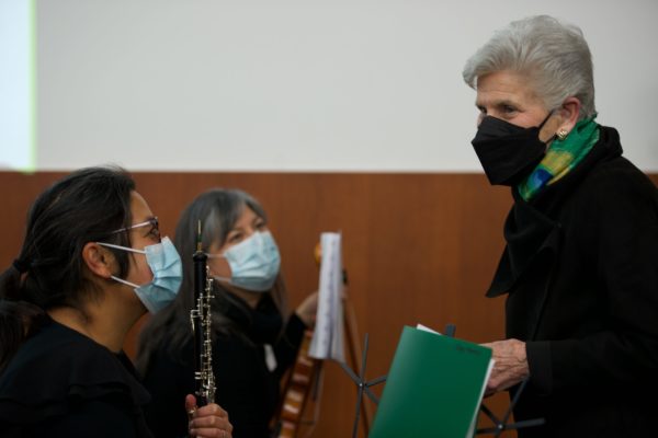 Dr. Ellen Wald talking to a woman holding an oboe