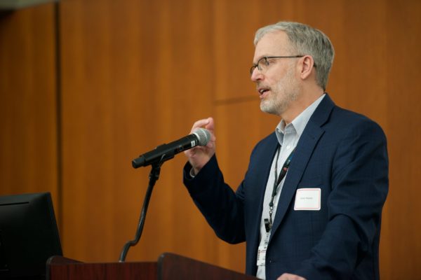 Dr. Carter Ralphe speaking into microphone