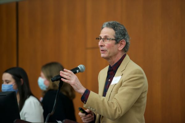 Dr. Bruce Klein speaking into a microphone