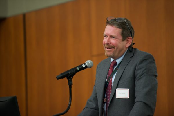 Dr. Tom Brazelton speaking into microphone