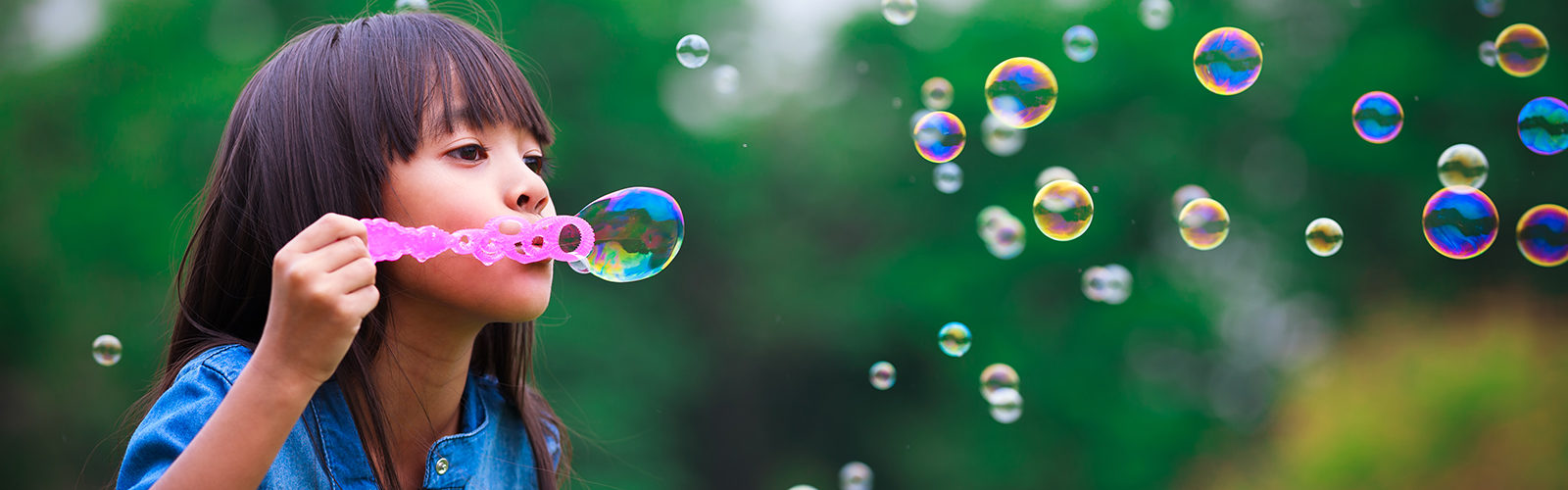 child blowing bubbles