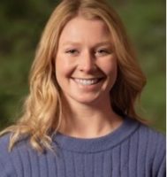 a portrait of a smiling white woman against a green background