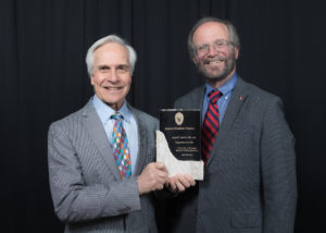 Dr. Paul Sondel holding an award next to UW SMPH Dean Robert Golden