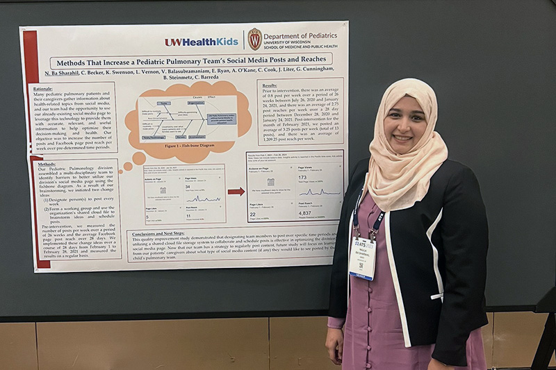 woman standing in front of a scientific poster