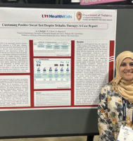 woman standing in front of a scientific poster