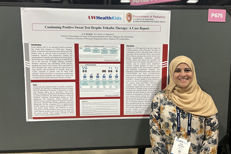 woman standing in front of a scientific poster