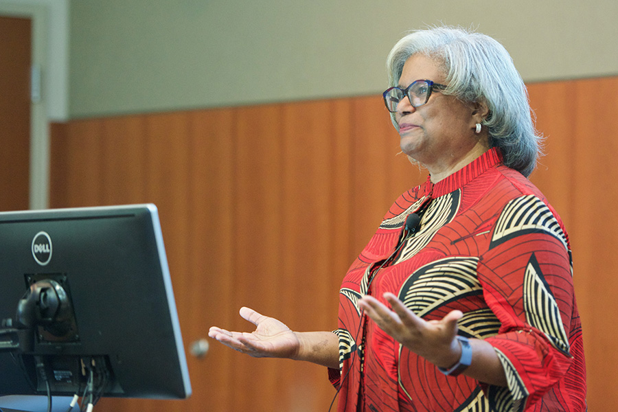 woman giving lecture at podium