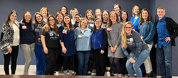 Group of 22 people smiling at camera