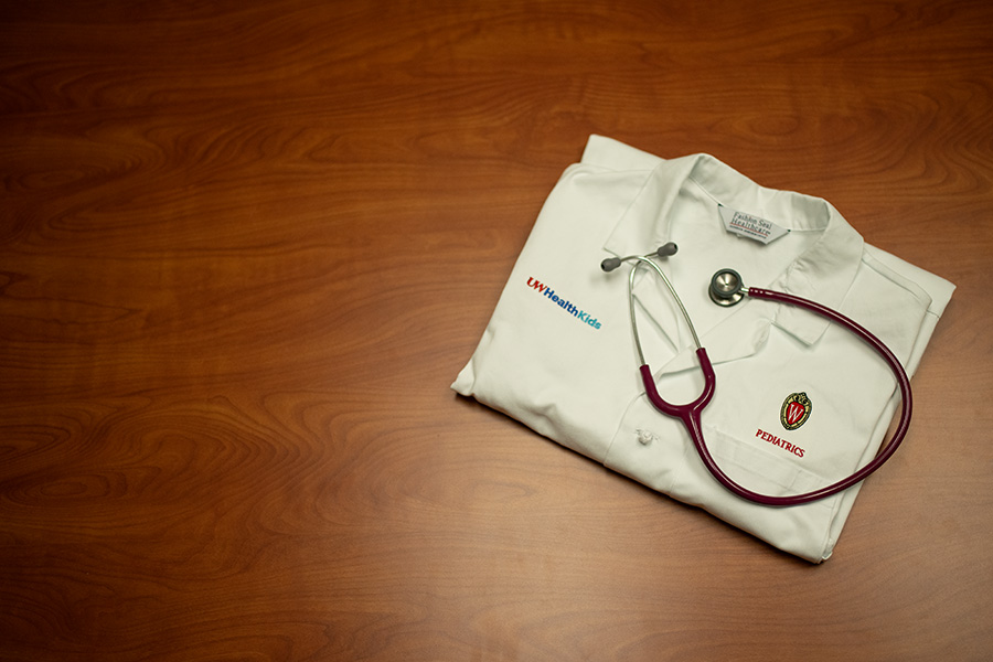 White doctor coat on a table with a stethascope