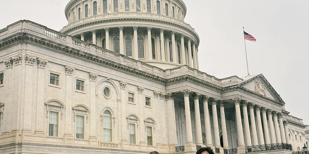 Three people standing in front of the US Capitol