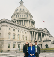 Three people standing in front of the US Capitol