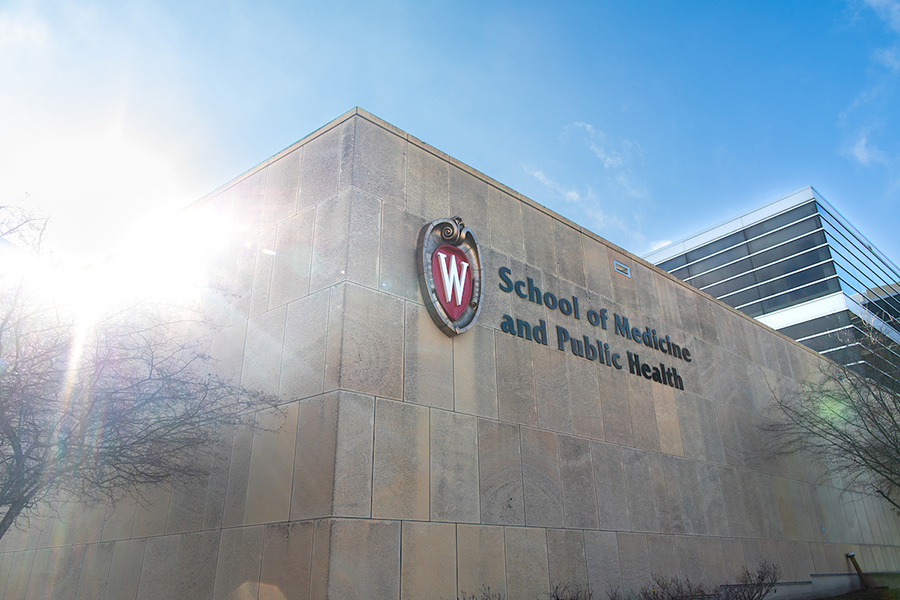 University of Wisconsin School of Medicine and Public Health Building with bright sun shining around corner of building