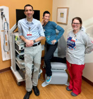 Group of three health care providers in a clinic office