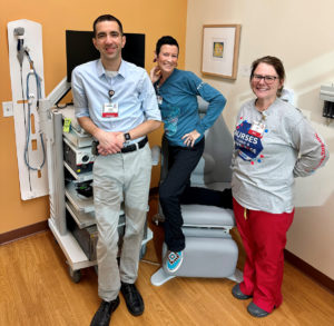 Group of three health care providers in a clinic office