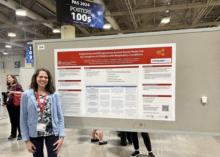 a woman in front of a scientific poster in a conference hall