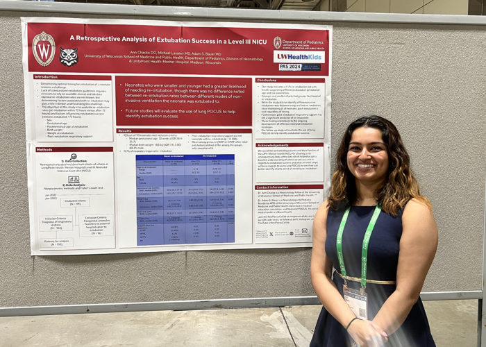 a woman in front of a scientific poster in a conference hall