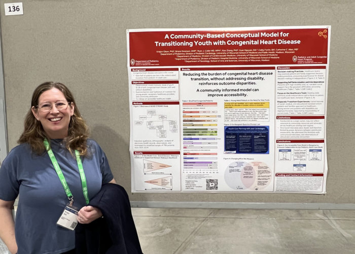 a woman in front of a scientific poster in a conference hall