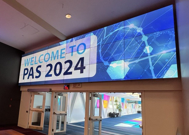A sign above a doorway that says Welcome to PAS 2024