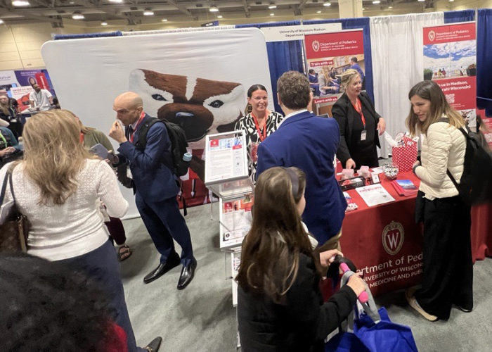 People gathered around a conference booth