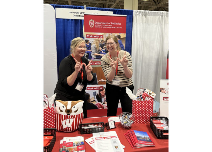 Two people at a conference booth