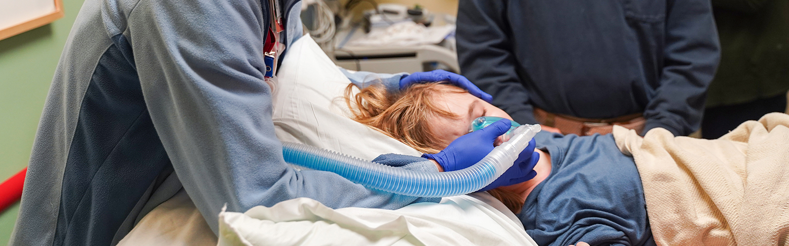 Pediatric patient in bed receiving sedation