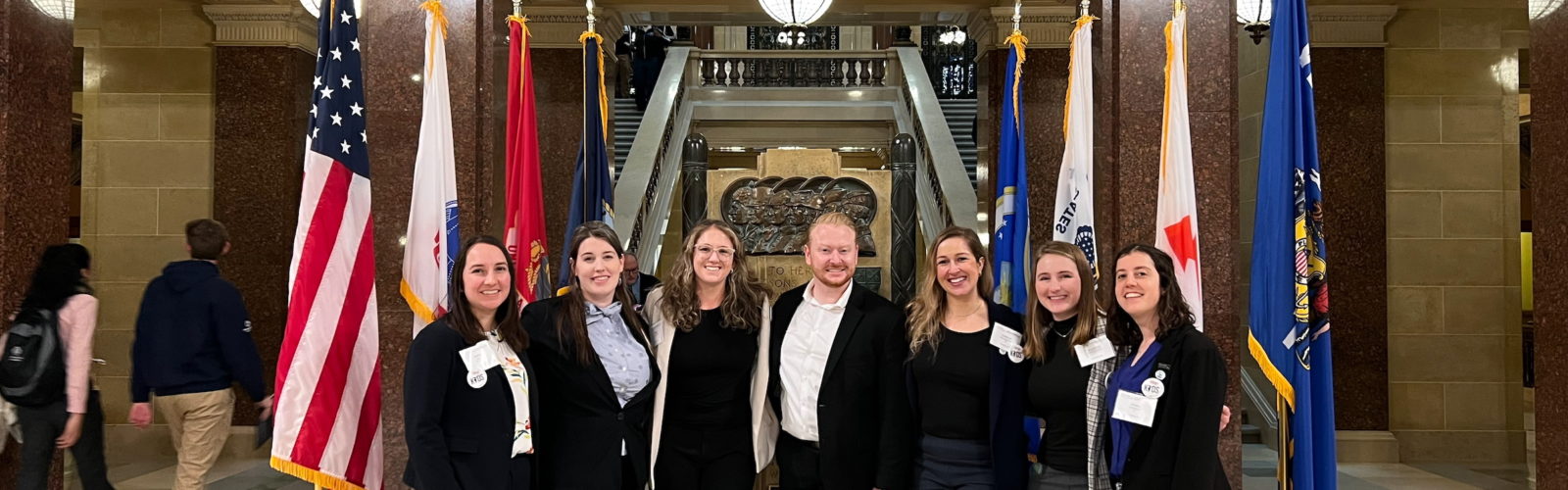 Seven pediatrics residents standing in front of the West Gallery of the Wisconsin State Capitol building.