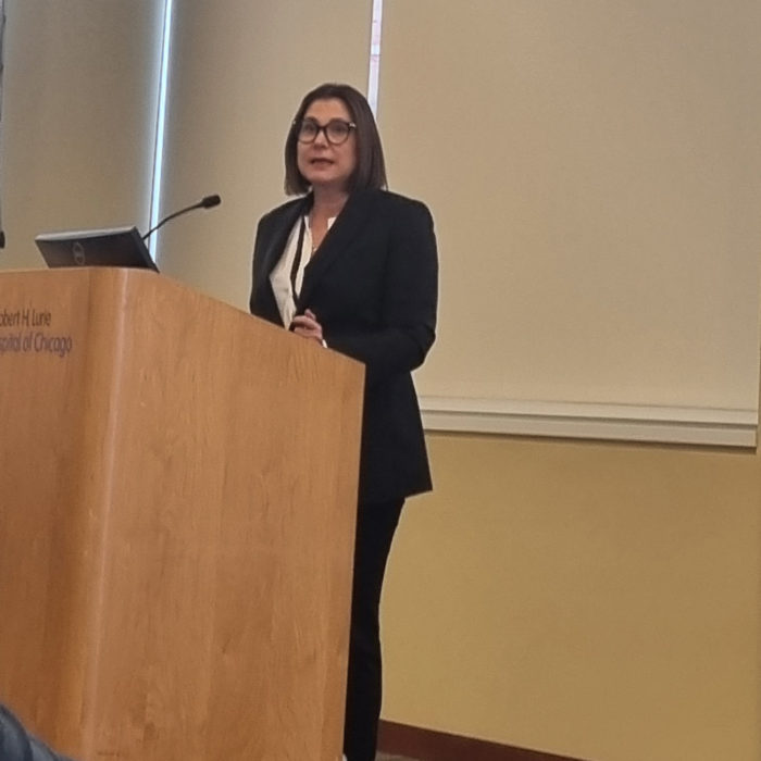 Pelin Cengiz giving lecture at podium.